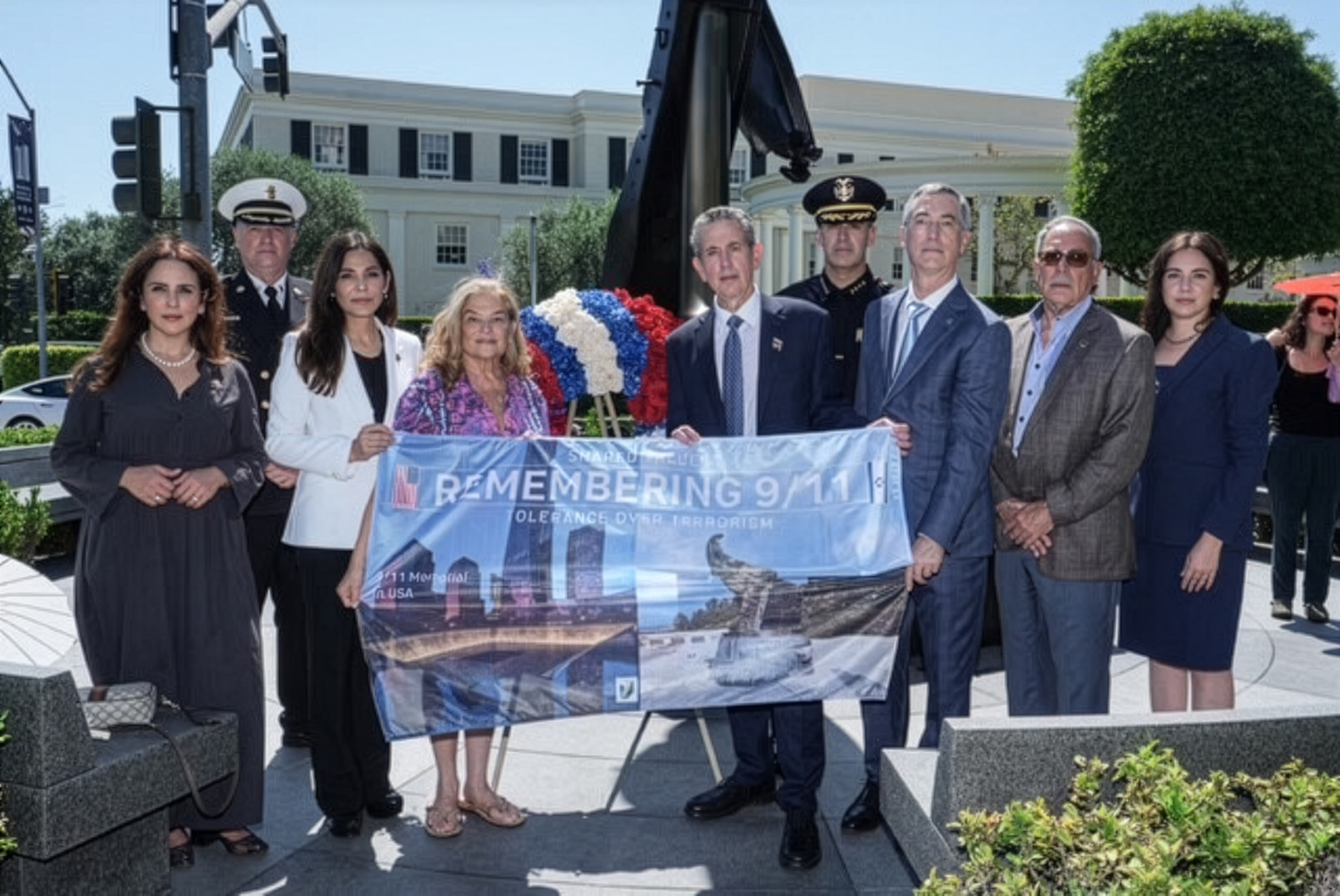 Council Members and Jewish National Fund-USA professionals and board members posing with local first responders and holding Jewish National Fund-USA Remembering 9/11 sign