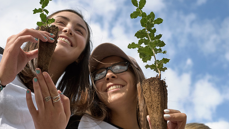 girls holding plants