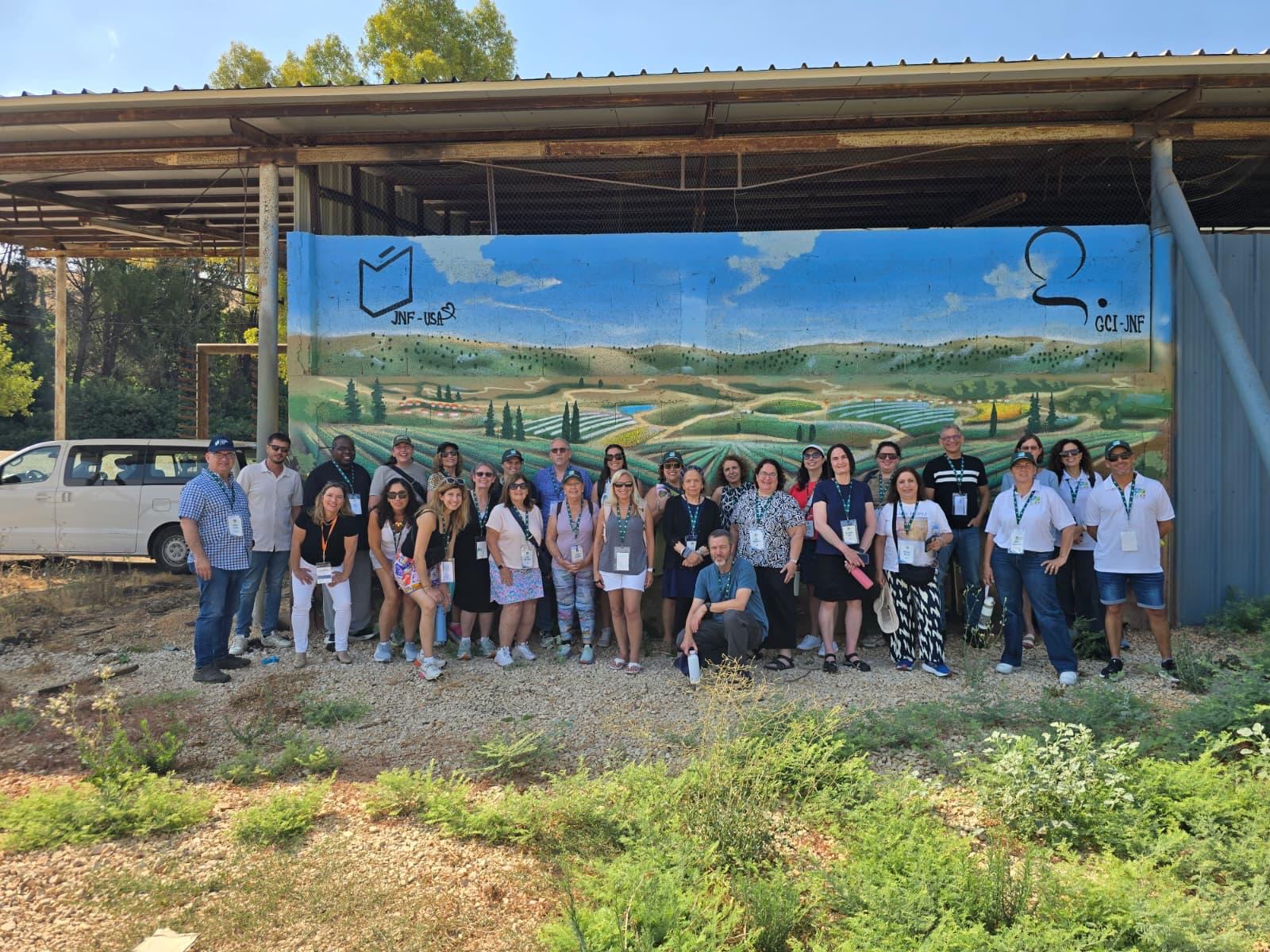 Jewish National Fund-USA Educators' Mission participants in front of a beautified bomb shelter at the Galilee Culinary Institute by JNF in northern Israel Jewish National Fund-USA Educators' Mission participants posing in front of a beautified bomb shelter at the Galilee Culinary institute by JNF in northern Israel