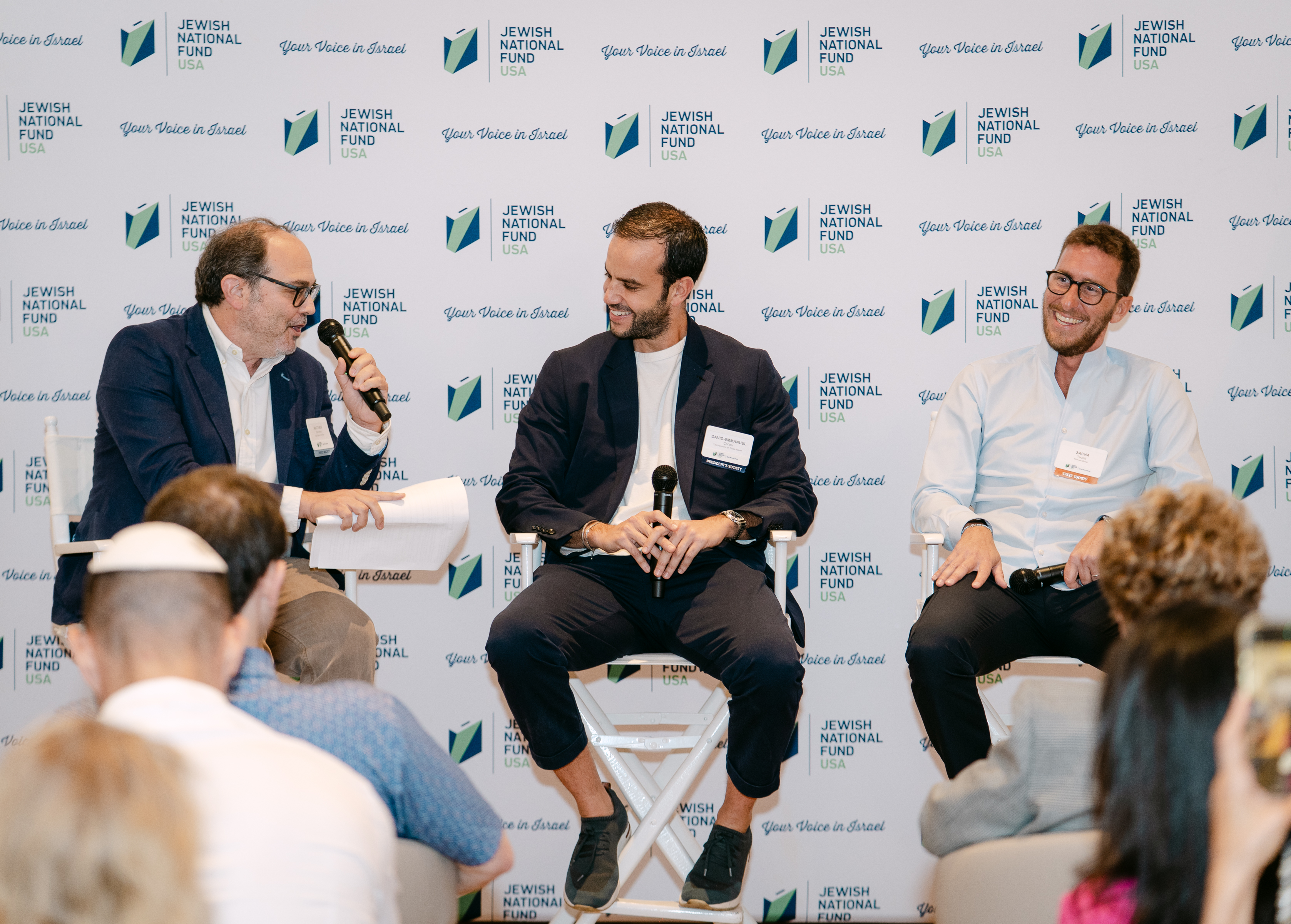 Matthew Krinzman, David-Emmanuel Cohen, Sacha Touret speaking on a panel in front of the crowd