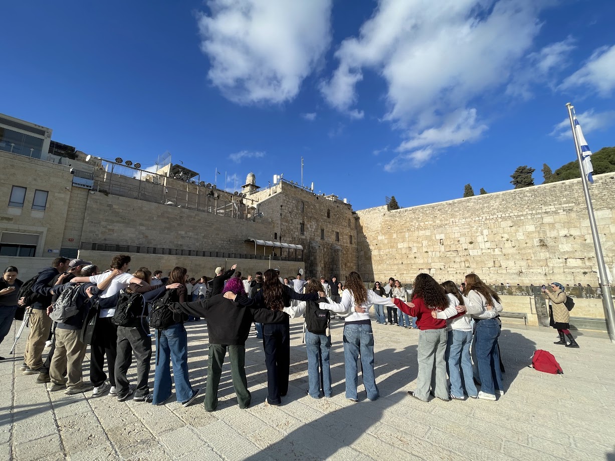 Muss students stand together at the Western Wall in Jerusalem during an Israel studies experience.