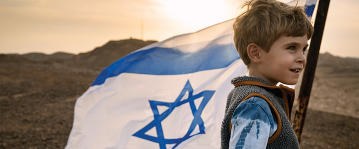 Boy with Israel flag at dusk