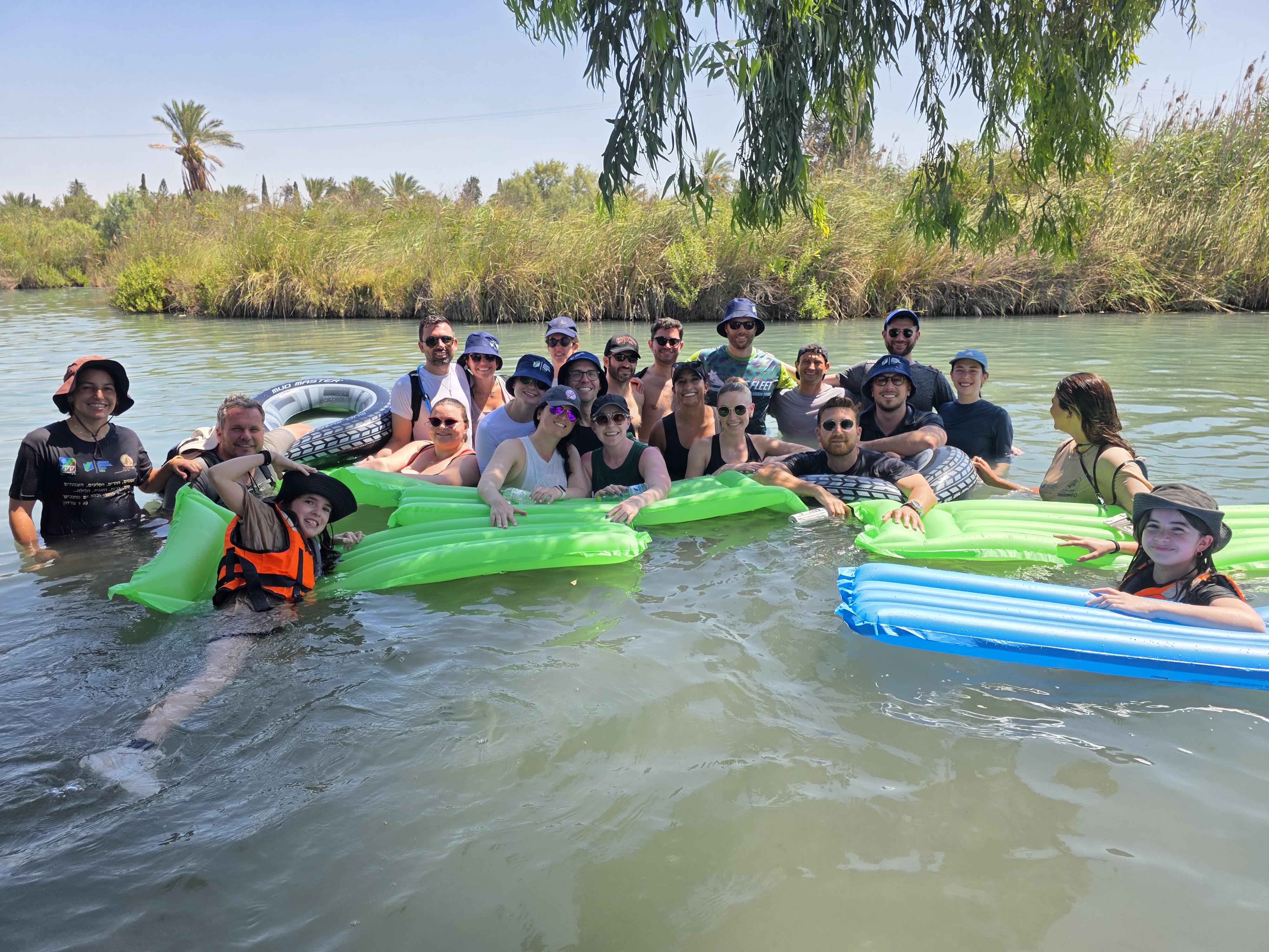 Participants enjoying a water hike with Green Horizons Participants posing for a photo in the water enjoying a water hike with green horizons