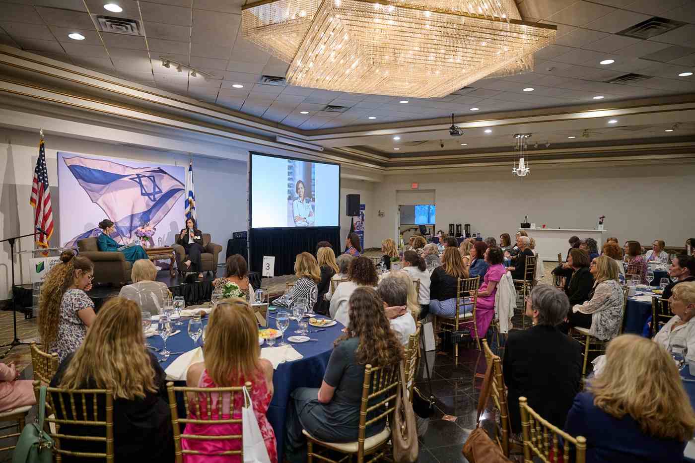 A group of event attendees watching a presentation