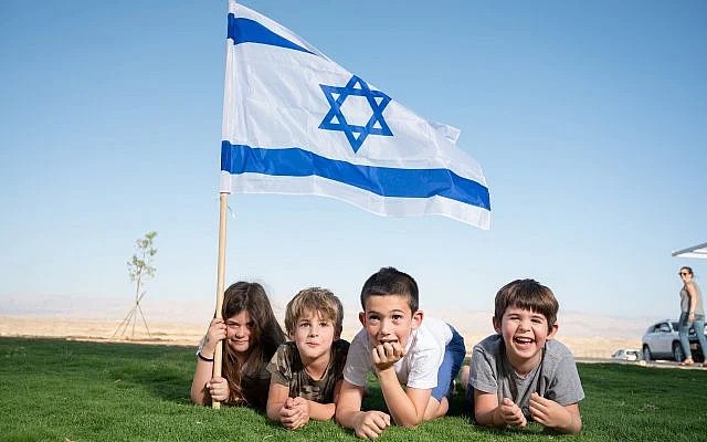 Young children holding Israel flag