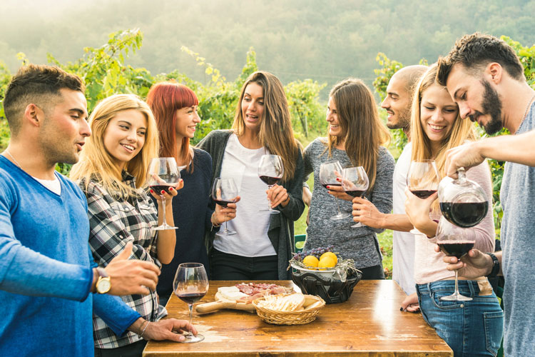 People Gathered Around the Table with Wine Glasses