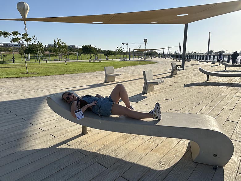 young woman laying on bench